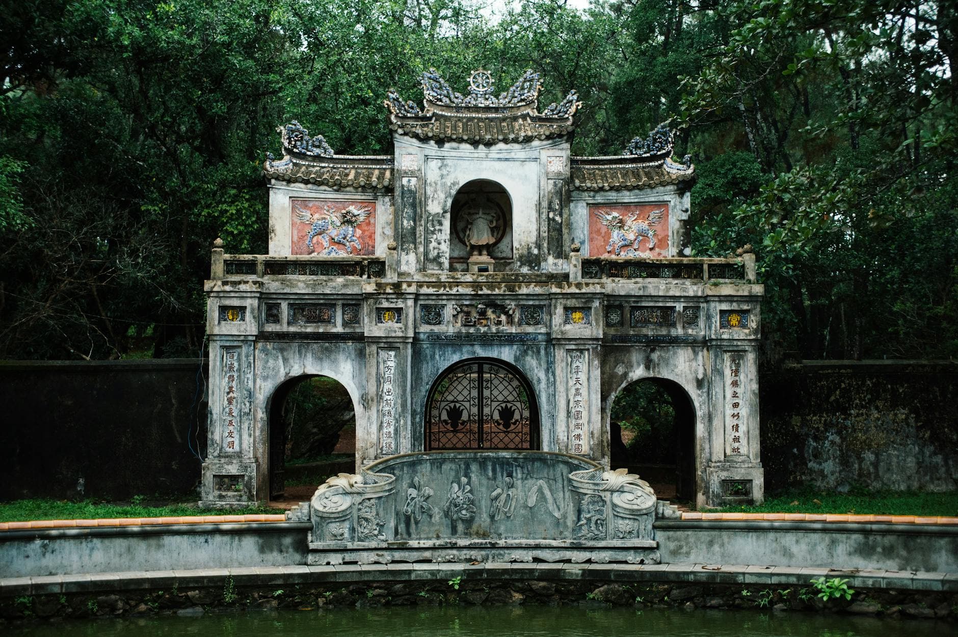 Ornate gate (cổng tam quan) of a Vietnamese Mahayana pagoda — the entry threshold visitors cross when joining Phật Đản ceremonies at Hội An's Tổ đình Chúc Thánh and three sister temples.