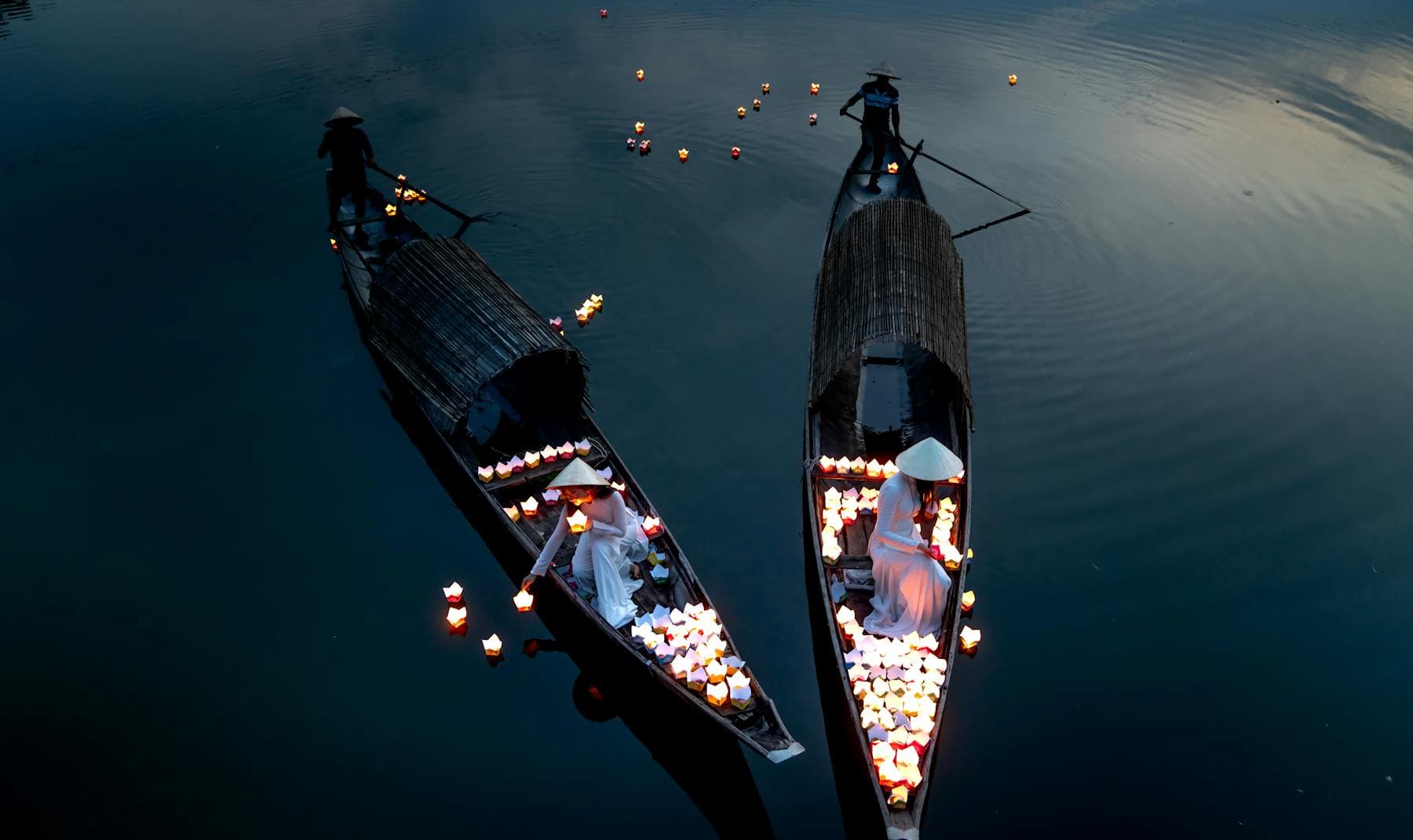 Hội An Ancient Town lit by silk lanterns at night during the Thu Bồn River lantern festival, Vietnam — pedestrian streets close to traffic for the monthly Đêm Rằm celebration
