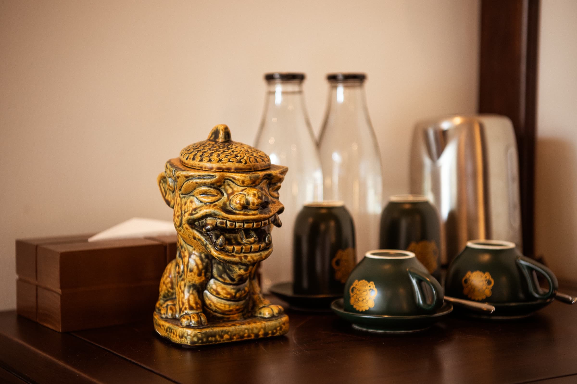 Minibar tray at Nghê Prana with the branded Nghê tea service, kettle and glass water bottles