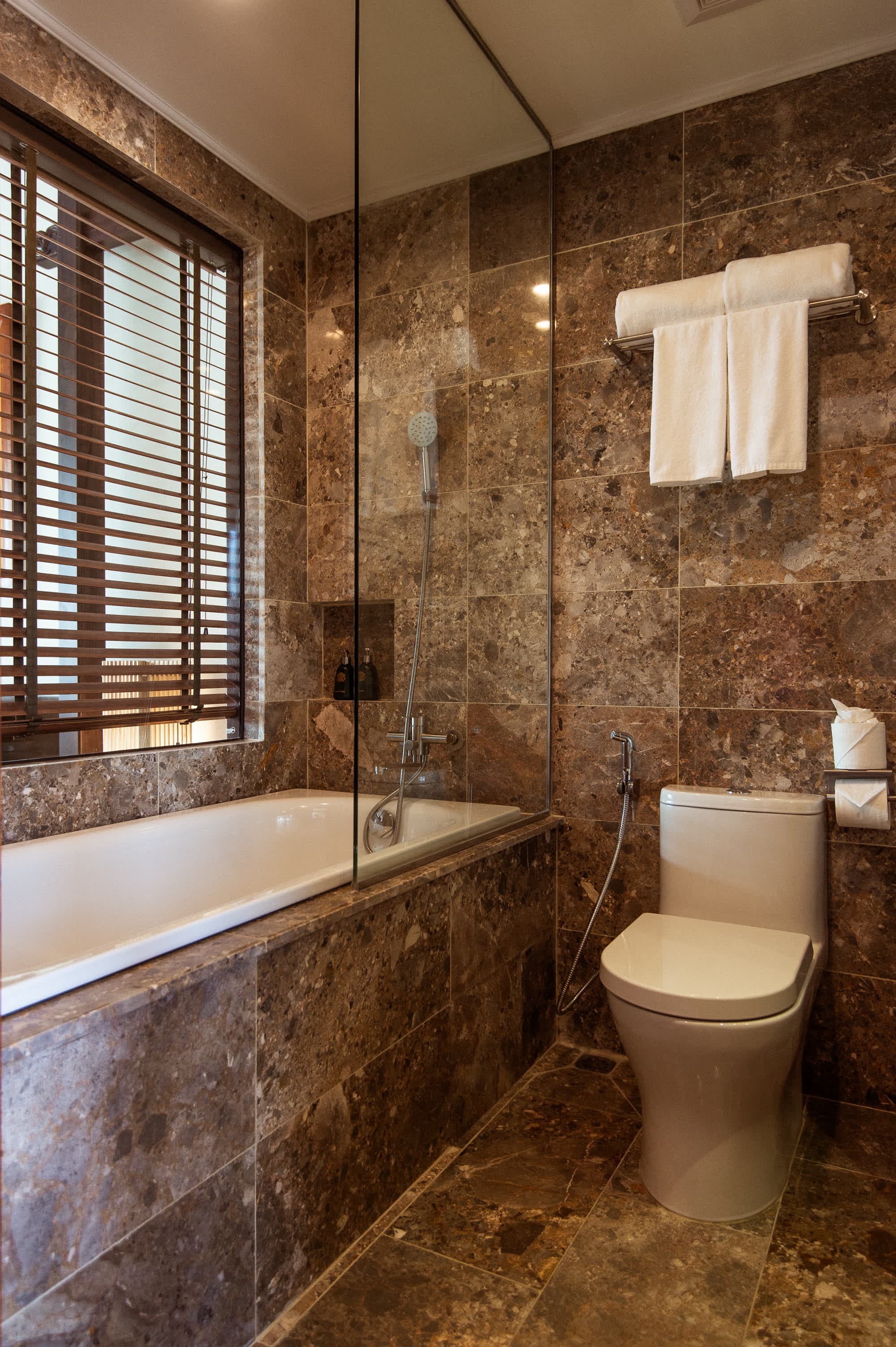 Bathtub and glass-screened shower in the River Suite bathroom