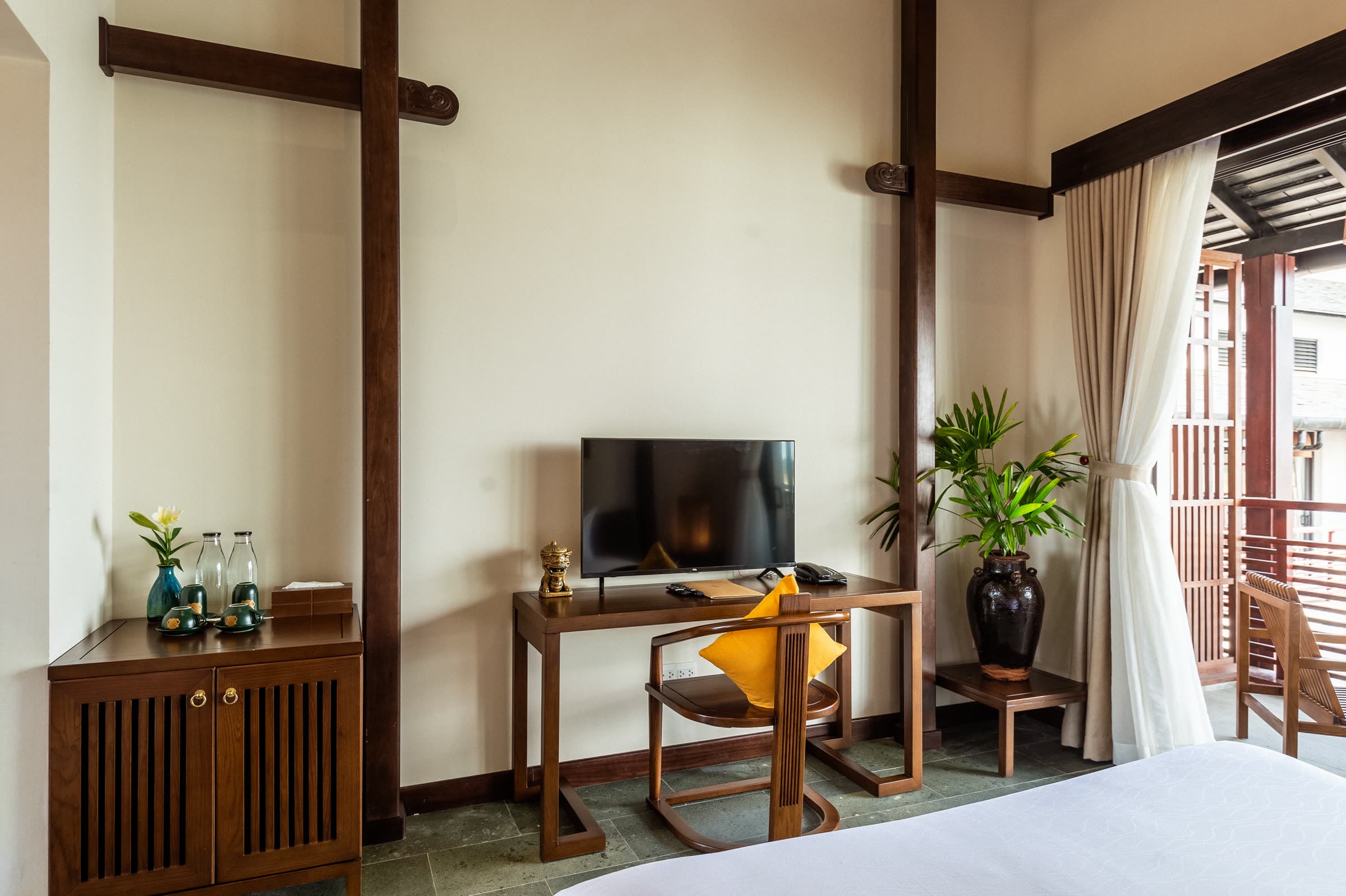 Deluxe Double room with the balcony door open to the riverside walkway