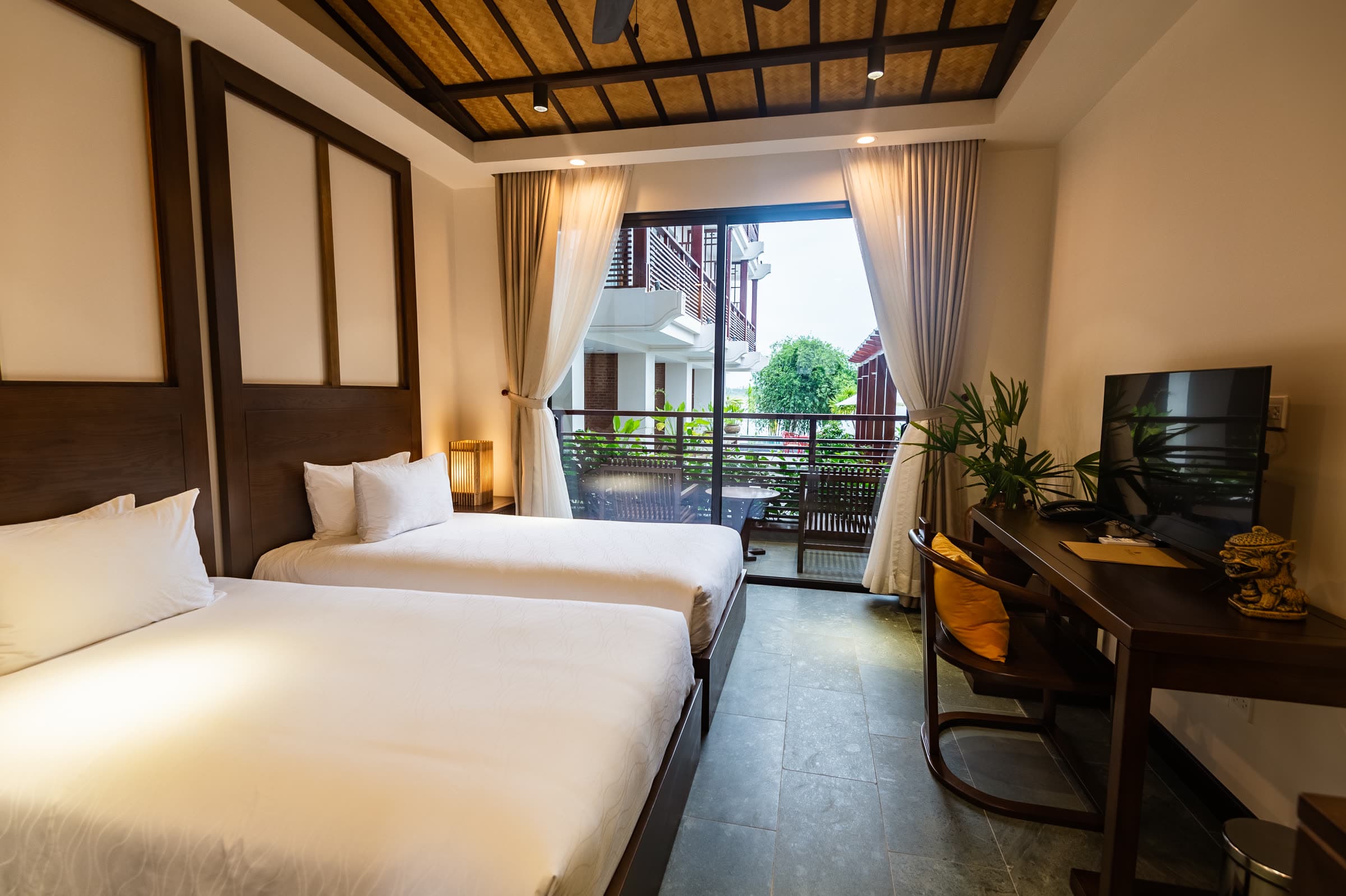 Twin beds beside the balcony doors of the Ying and Yang room