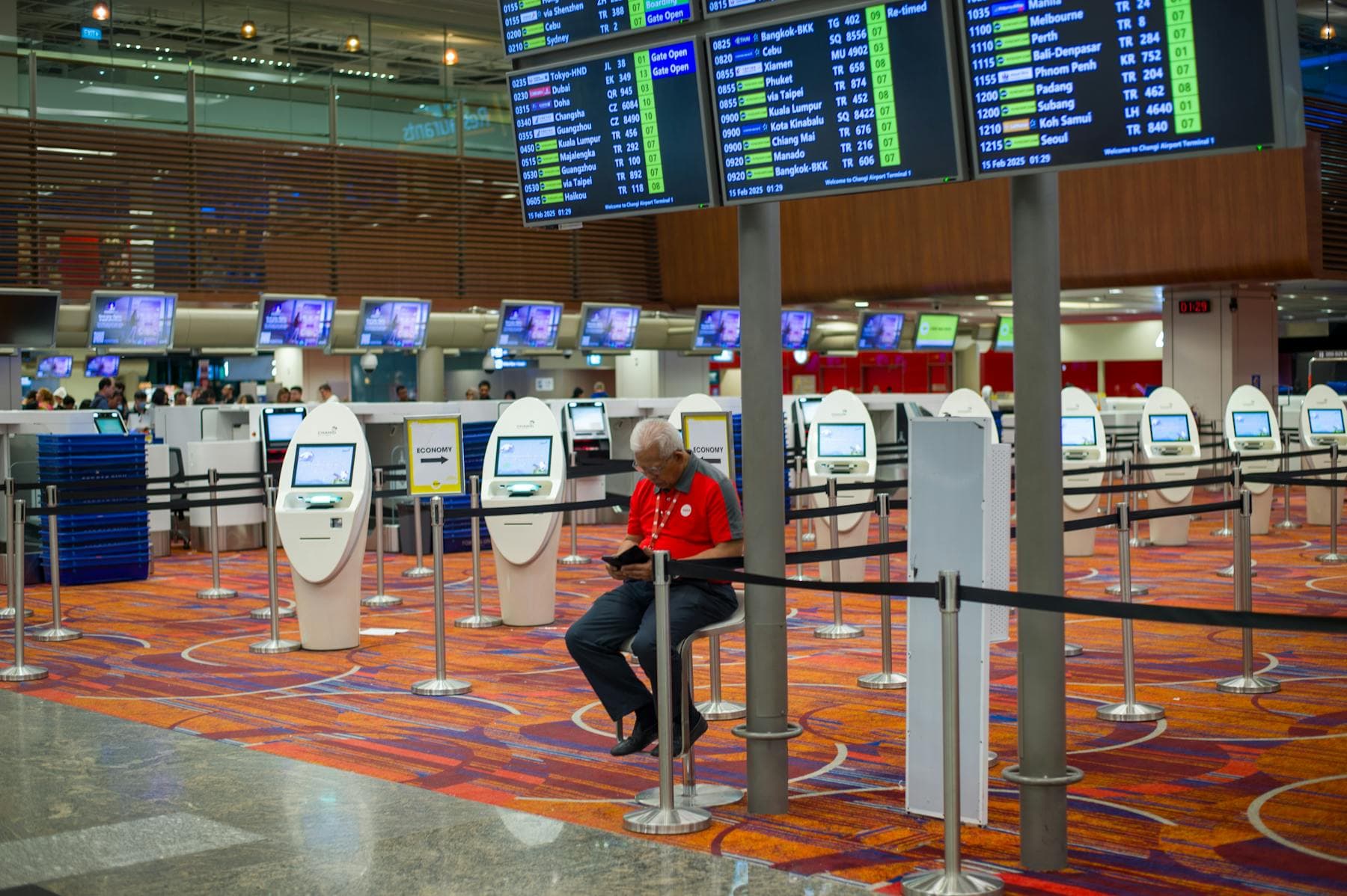 Da Nang International Airport (DAD) Terminal 2 arrivals hall with check-in counters and a traveler waiting — gateway to Hội An