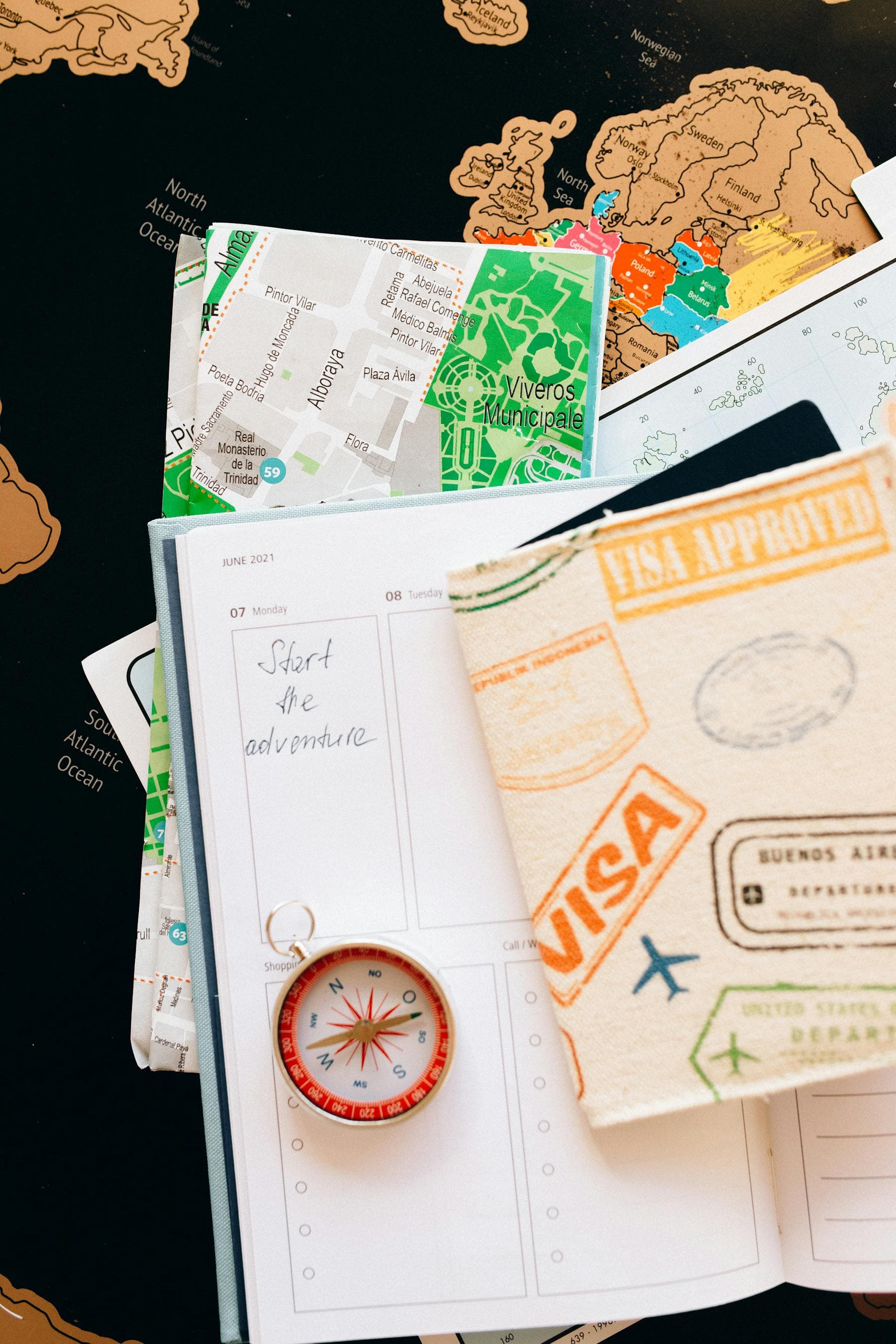 Travel planner with compass, world map and visa stamps for plotting how far Hội An hotels are from the Old Town and Japanese Bridge