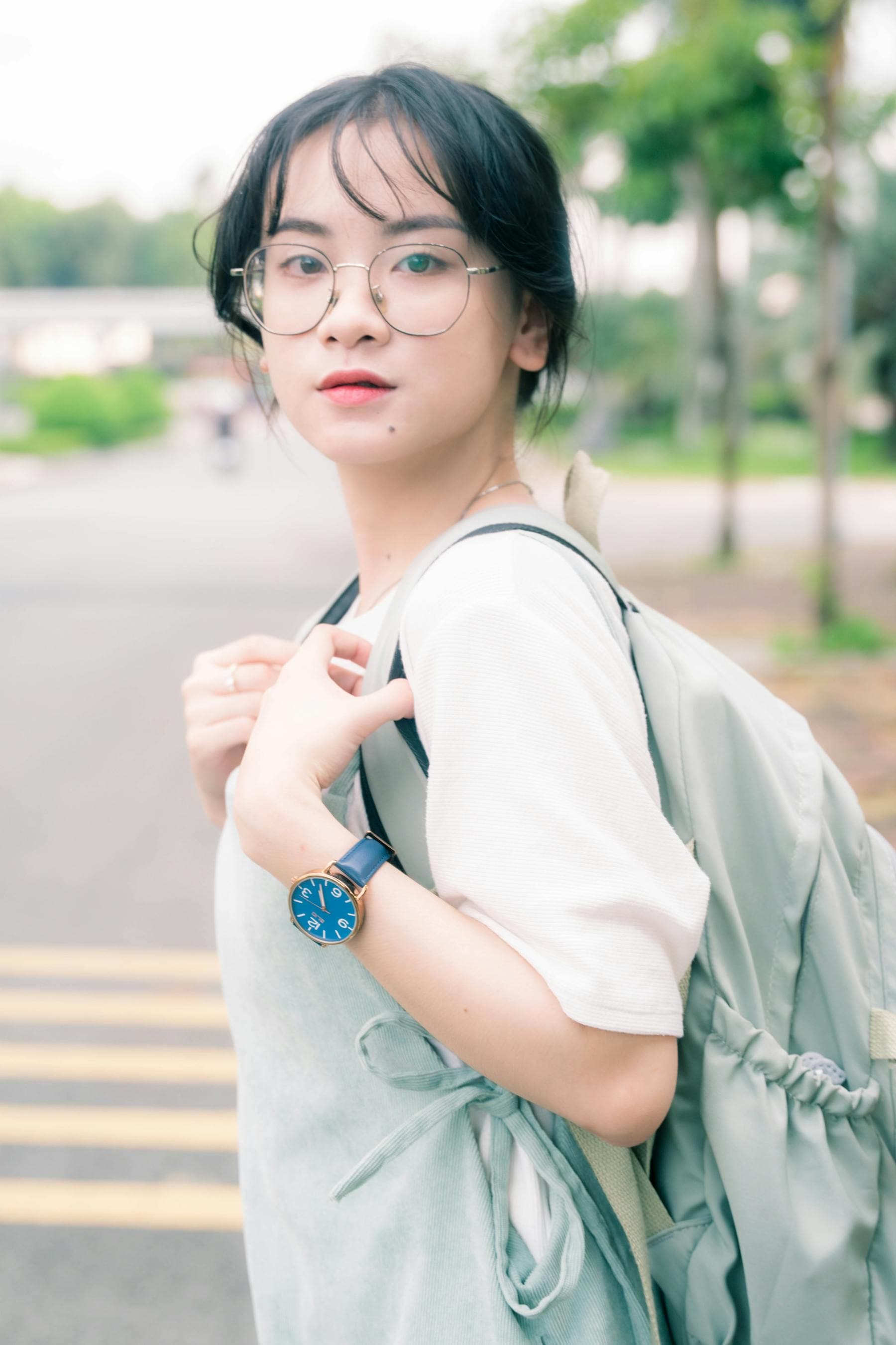 Asian woman traveler with backpack and watch on a Vietnam street — Korean travelers 4 day Hoi An itinerary 2026