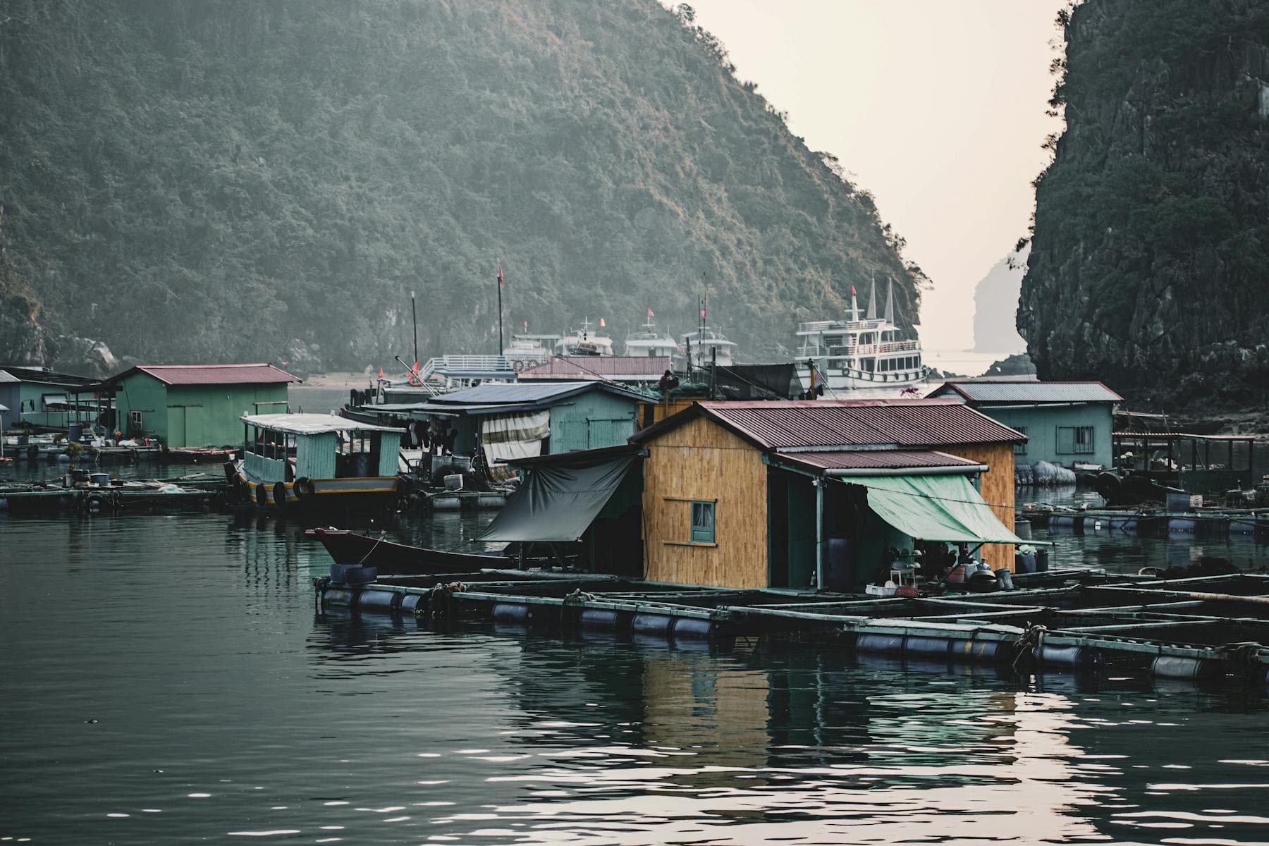 Floating fishing village in Ha Long Bay northern Vietnam with karst cliffs — choosing north central south Vietnam first trip