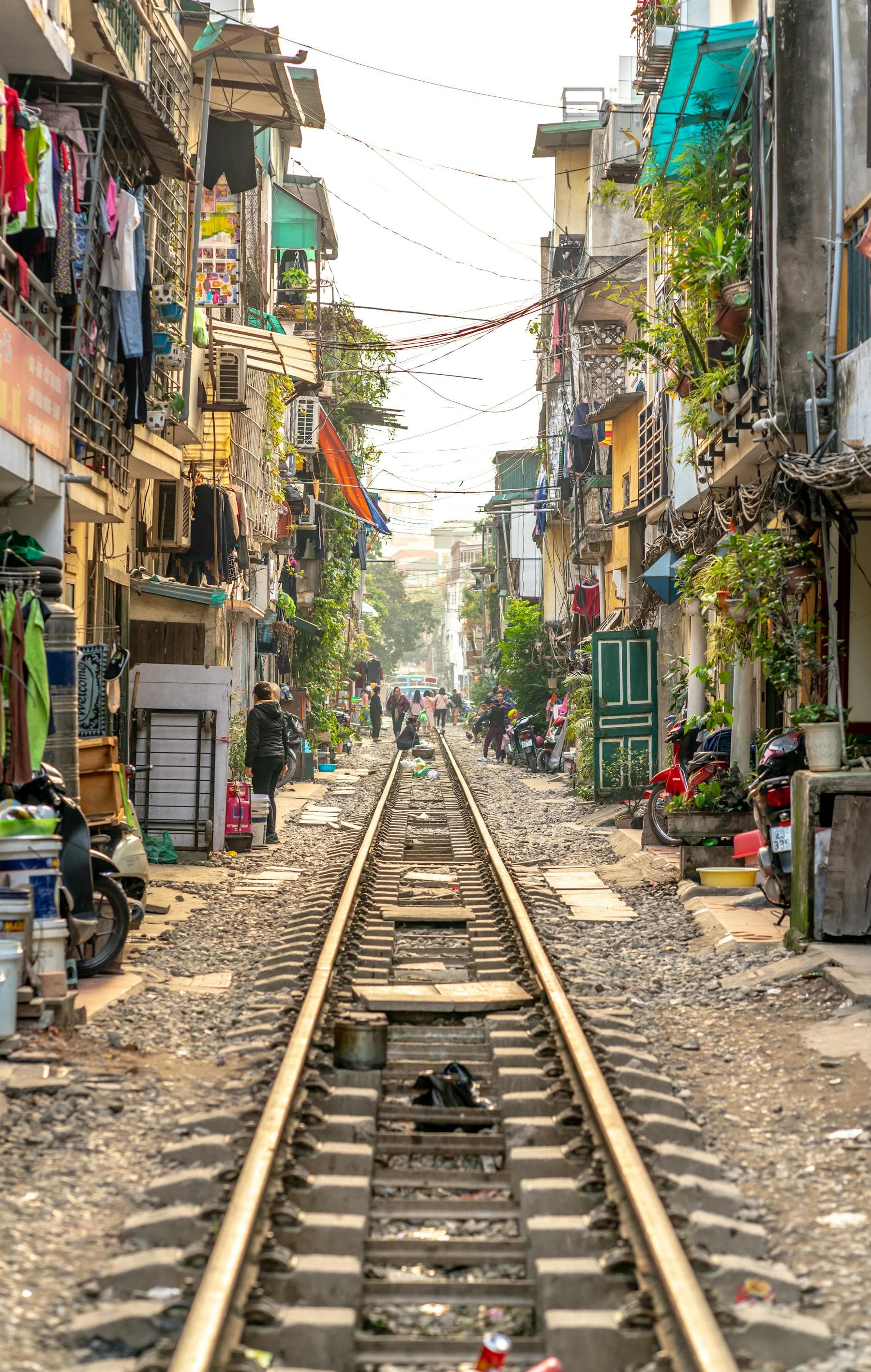 Hanoi Train Street between tightly packed houses in Vietnam — 2026 tourism surge and quiet alternatives in Hoi An